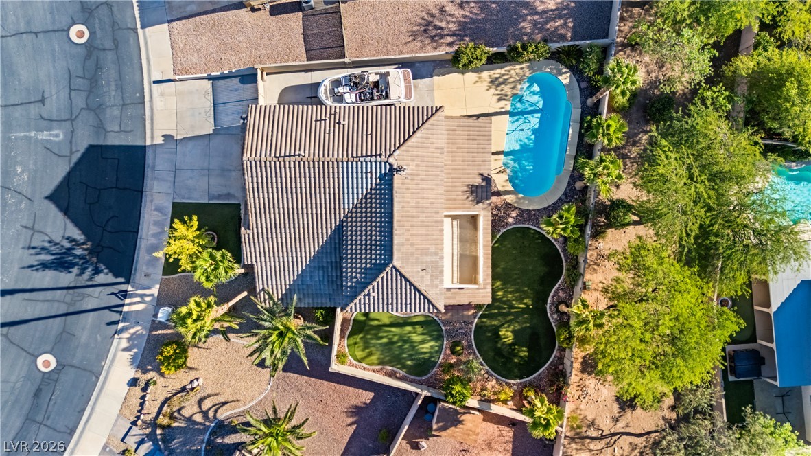 708 Vortex Avenue Henderson, NV 89002 - Photo 3 of 71 An aerial perspective reveals a private yard with a refreshing pool, ample parking, and well-maintained landscaping.