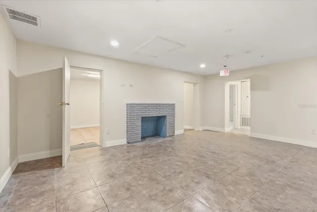 a view of an empty room with a fireplace
