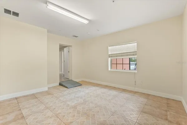 an empty room with a empty space and windows