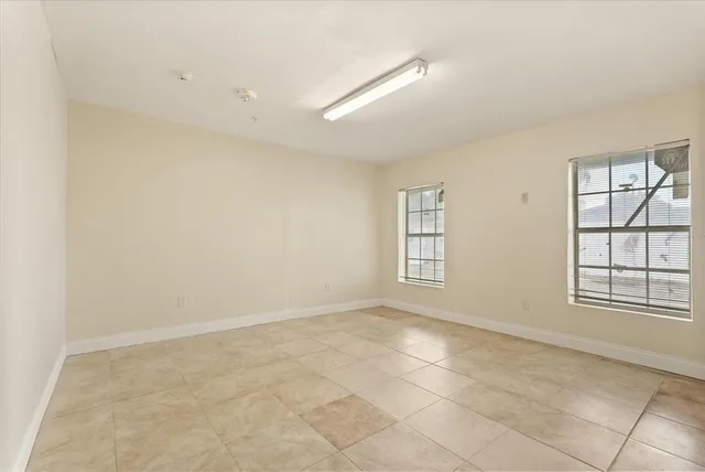 an empty room with windows and closet