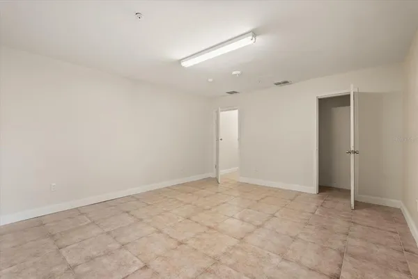 an empty room with white walls and tiles