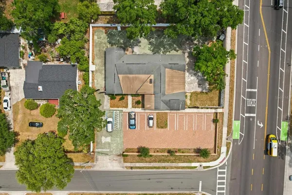 aerial view of a house with a yard and large tree