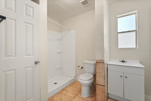 a bathroom with a toilet a sink and shower