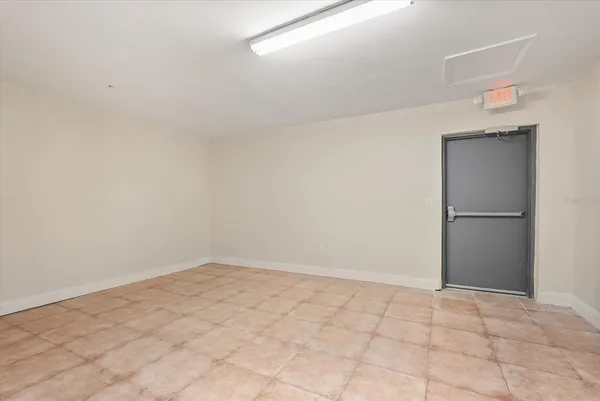 a view of a livingroom with an empty space and a window