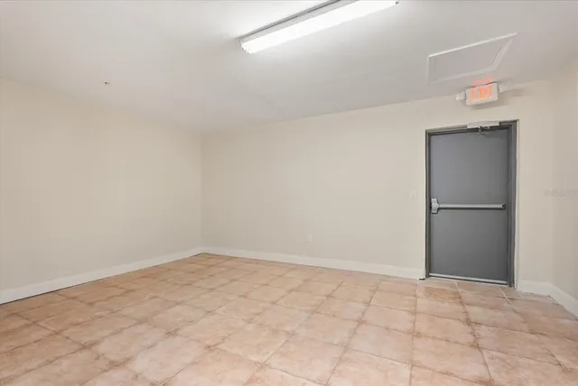 a view of a livingroom with an empty space and a window