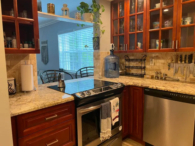 a kitchen with granite countertop a stove and a sink