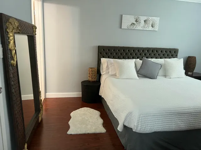 a bed sitting in a bedroom next to a window