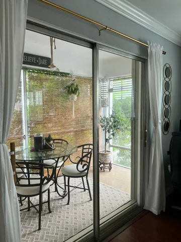 a view of a room with a table and chairs