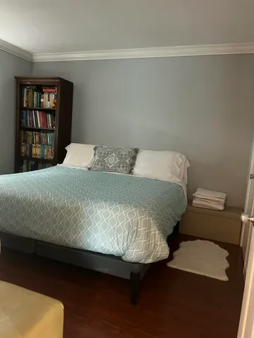 a bedroom with a bed and window