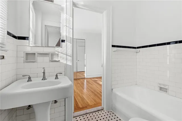 a bathroom with a sink a bathtub and a shower
