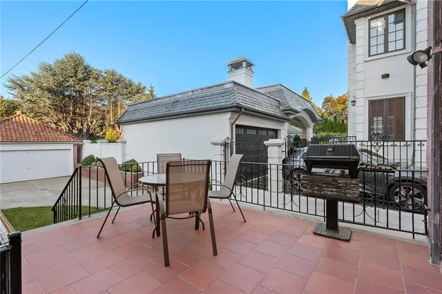 a view of a chairs and tables in the back yard of the house