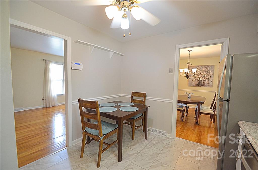 7433 Riding Trail Road Charlotte, NC 28212 - Photo 17 of 42 a view of a dining room with furniture and wooden floor