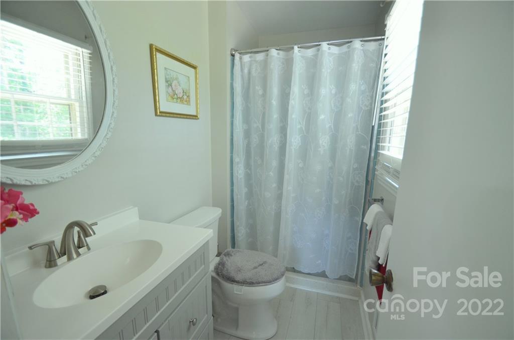 7433 Riding Trail Road Charlotte, NC 28212 - Photo 23 of 42 a bathroom with a sink toilet and shower