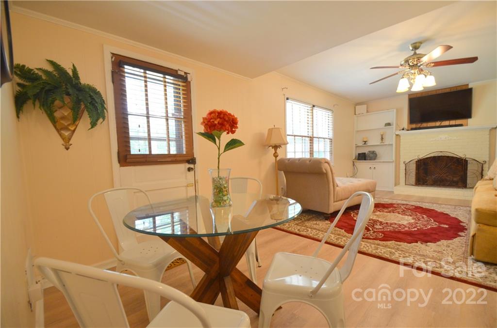 7433 Riding Trail Road Charlotte, NC 28212 - Photo 32 of 42 a living room with fireplace furniture and a flat screen tv