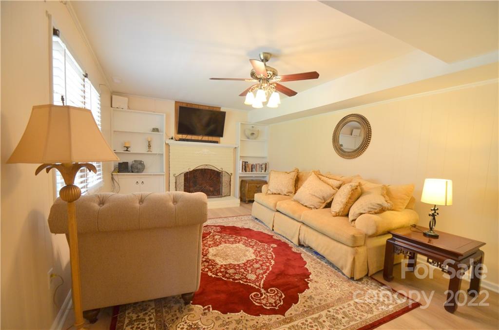 7433 Riding Trail Road Charlotte, NC 28212 - Photo 33 of 42 a living room with furniture a fireplace and a window