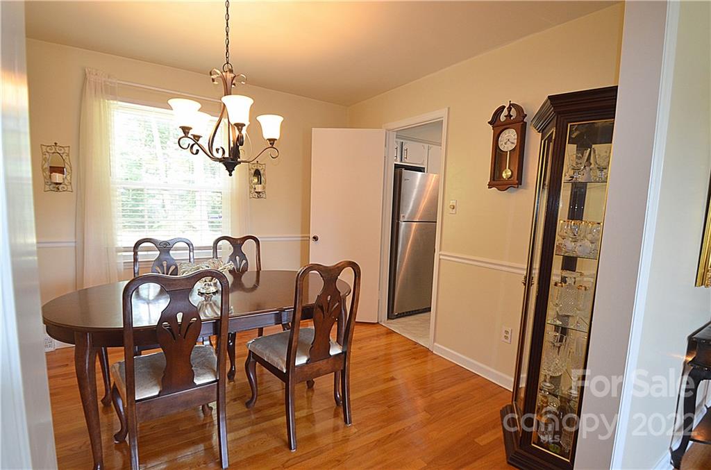 7433 Riding Trail Road Charlotte, NC 28212 - Photo 10 of 42 a view of a dining room with furniture window and wooden floor