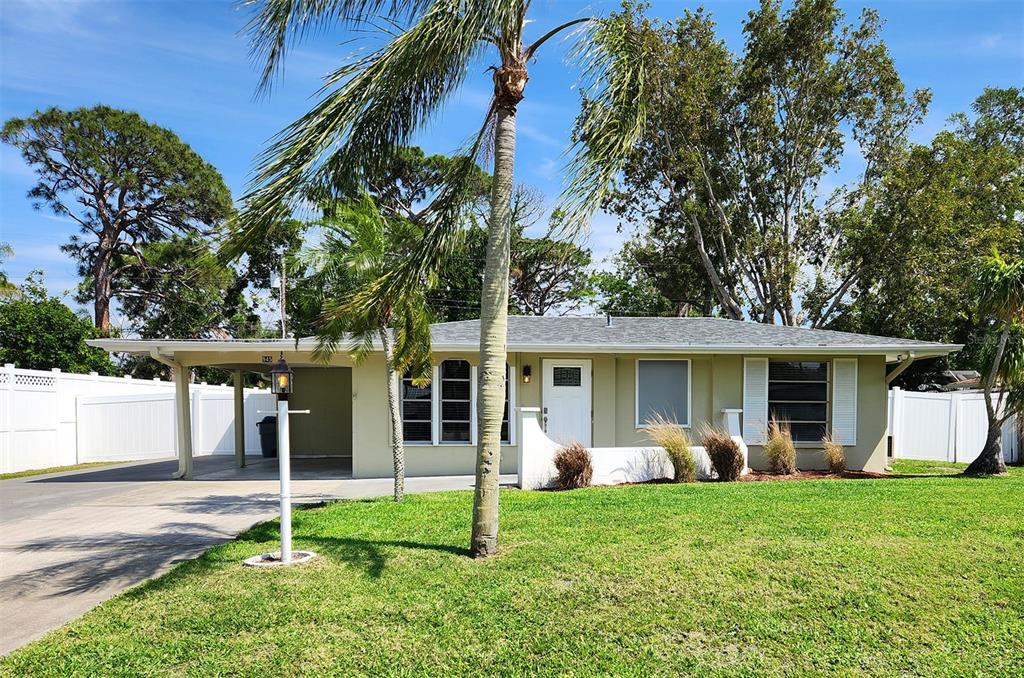 945 Piedmont Road Venice, FL 34293 - Photo 1 of 1 a view of a house with backyard porch and a tree