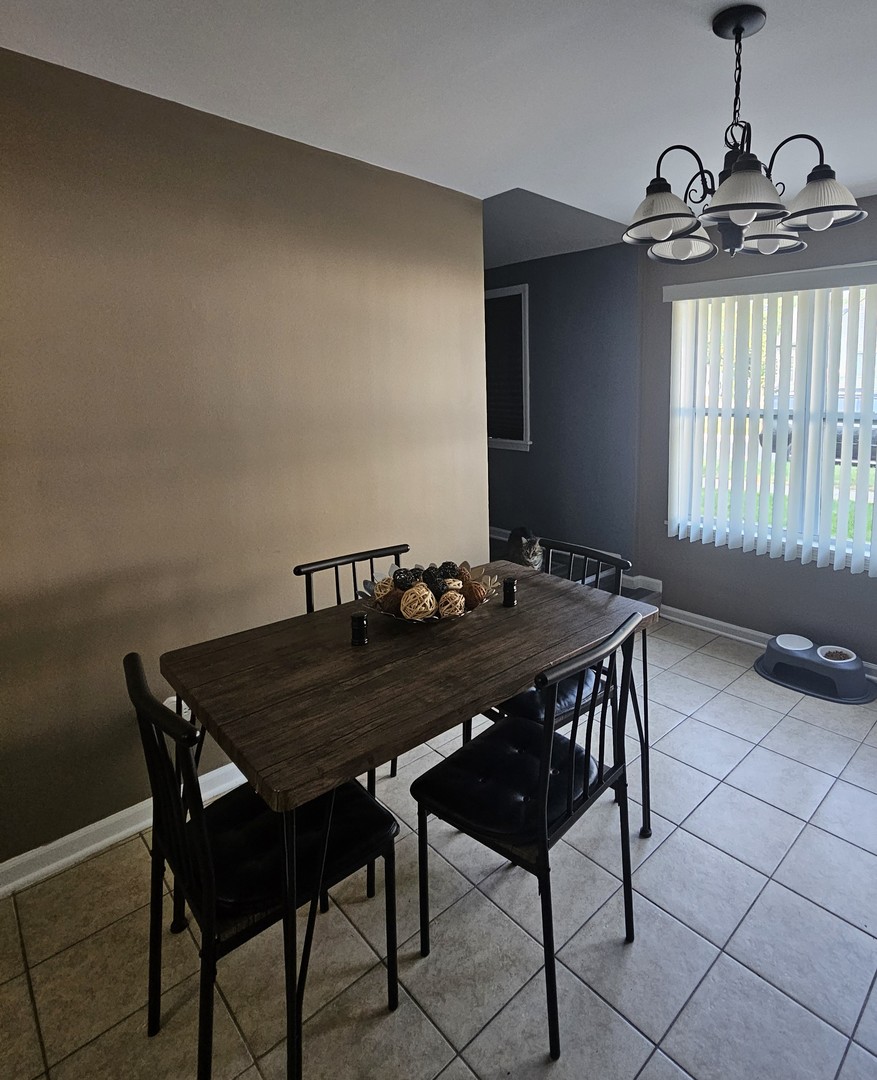 900 Charles Street Aurora, IL 60506 - Photo 4 of 14 a view of a dining table and chairs in a room