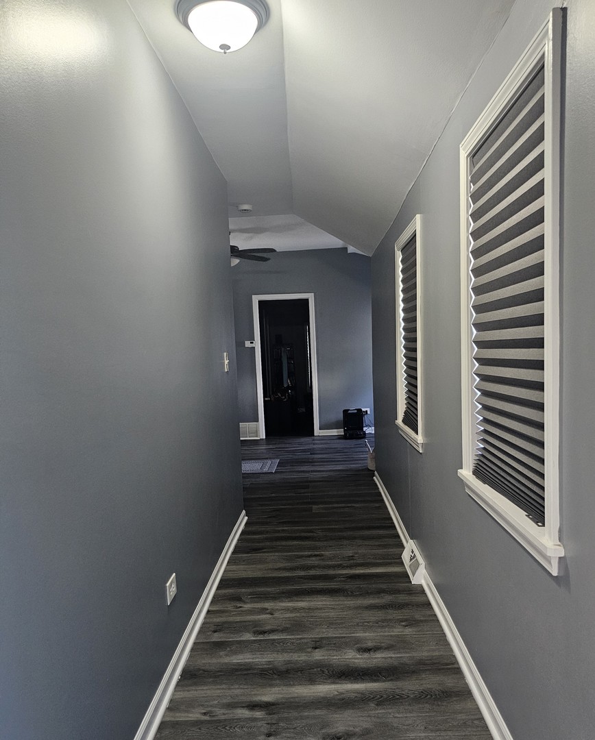 900 Charles Street Aurora, IL 60506 - Photo 5 of 14 a view of a hallway with wooden floor and a chandelier