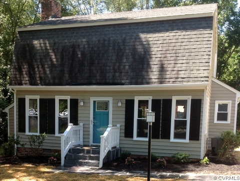 a view of a house with a yard and sitting area