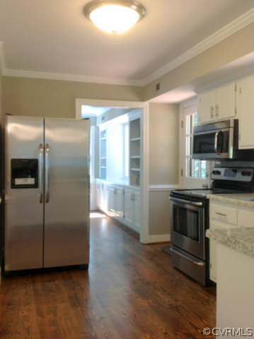 9713 Kendrick Road Richmond, VA 23236 - Photo 5 of 11 a kitchen with granite countertop a refrigerator and a stove top oven