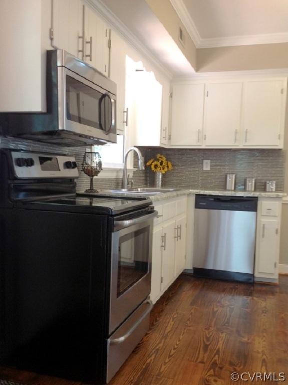 9713 Kendrick Road Richmond, VA 23236 - Photo 7 of 11 a kitchen with stainless steel appliances granite countertop a stove a sink and a microwave