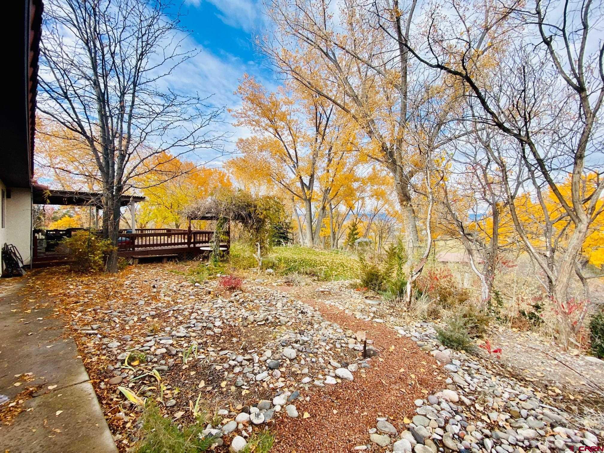 1755 F50 Road Delta, CO 81416 - Photo 22 of 30 a view of a yard with a house and trees