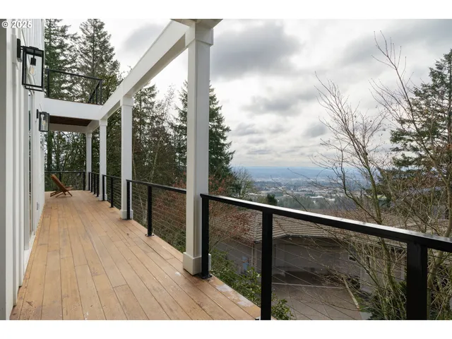 a view of balcony with wooden floor and fence