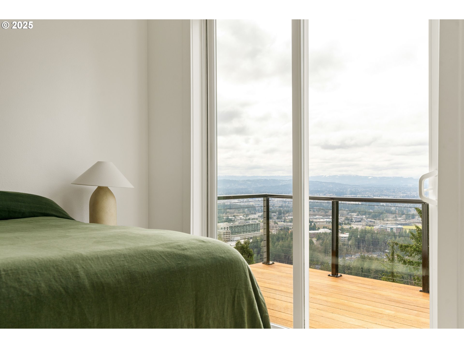290 Southwest Moonridge Place Portland, OR 97225 - Photo 16 of 46 a bedroom with a large window and a balcony