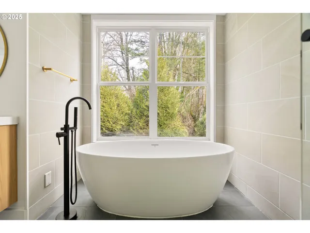 a white bath tub sitting next to a window