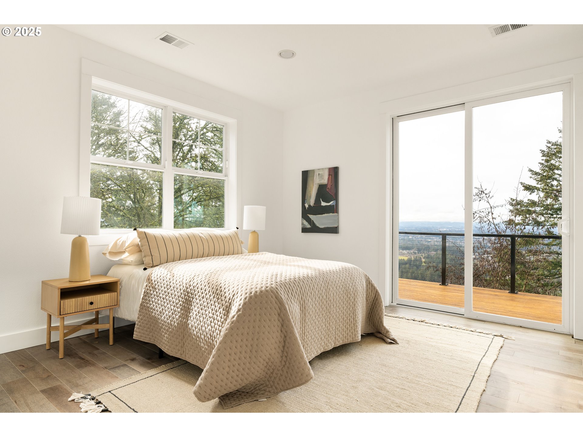290 Southwest Moonridge Place Portland, OR 97225 - Photo 22 of 46 a bedroom with a bed and a large window
