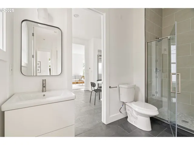 a bathroom with a toilet sink and shower