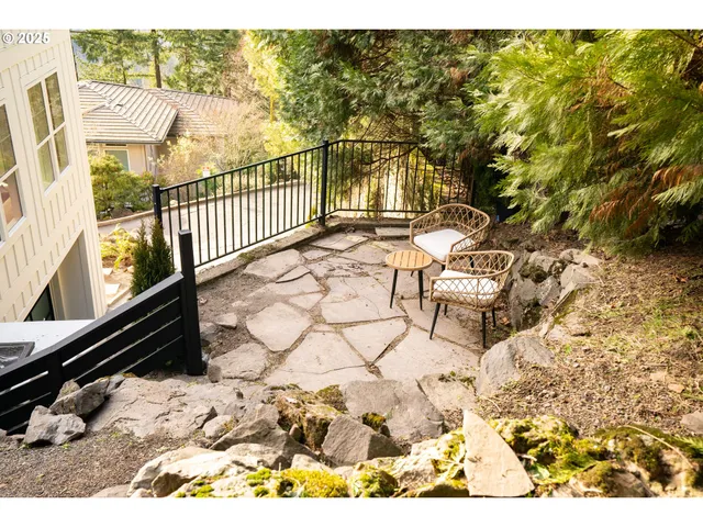 a view of a chairs and table in backyard