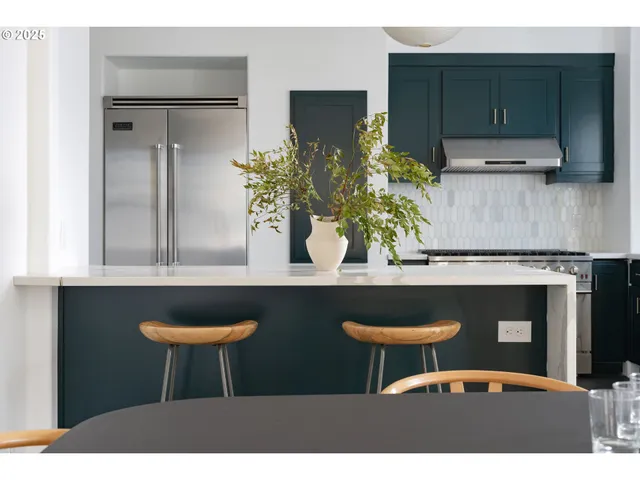 a table with chairs and a potted plant