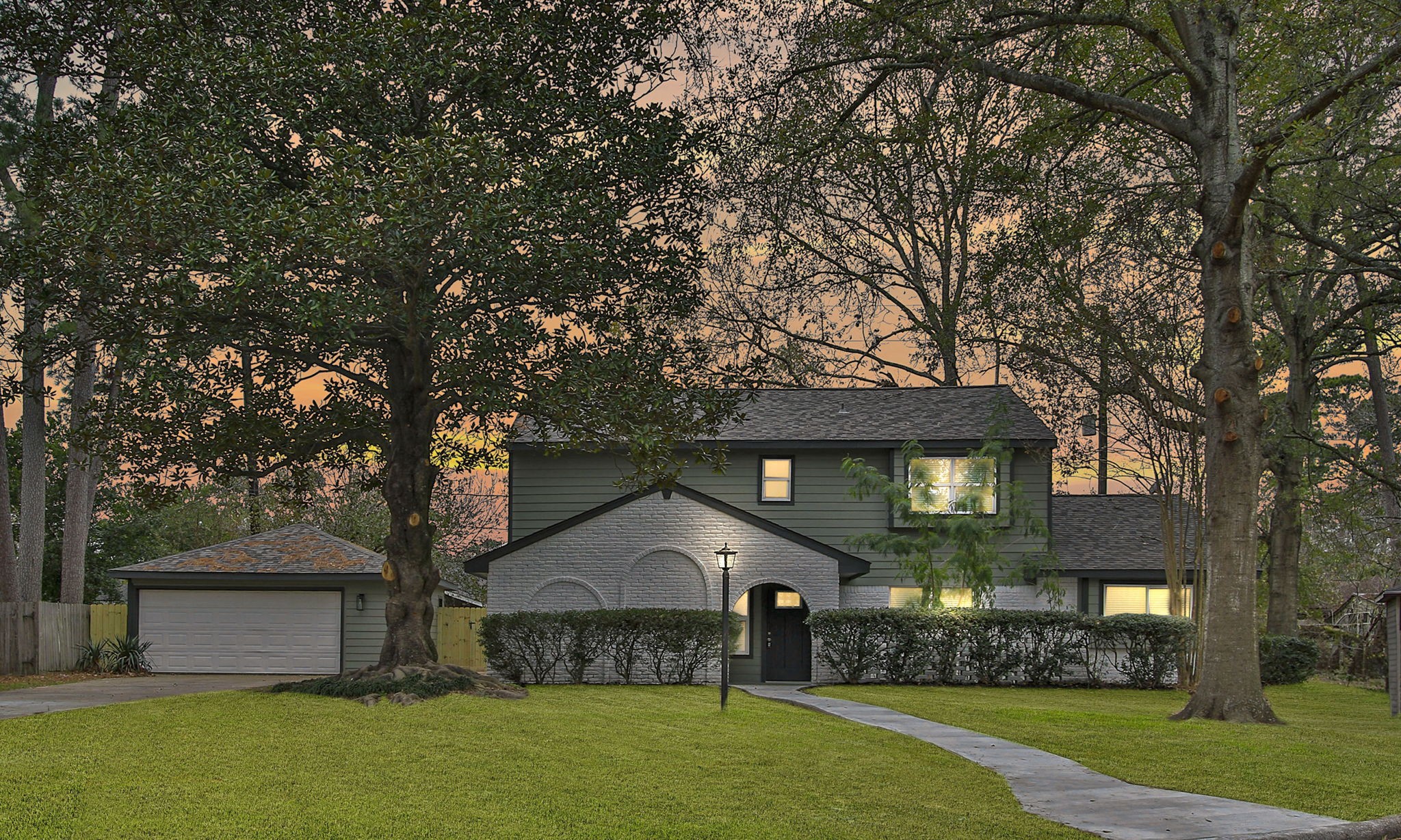 a front view of house with yard and green space