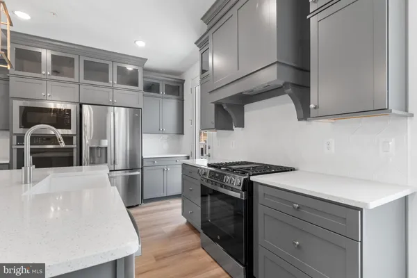 a kitchen with a sink stainless steel appliances and cabinets