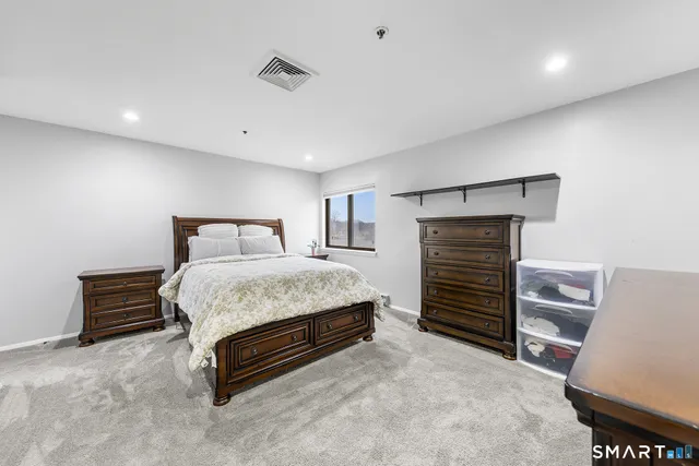 a bedroom with a bed and a television