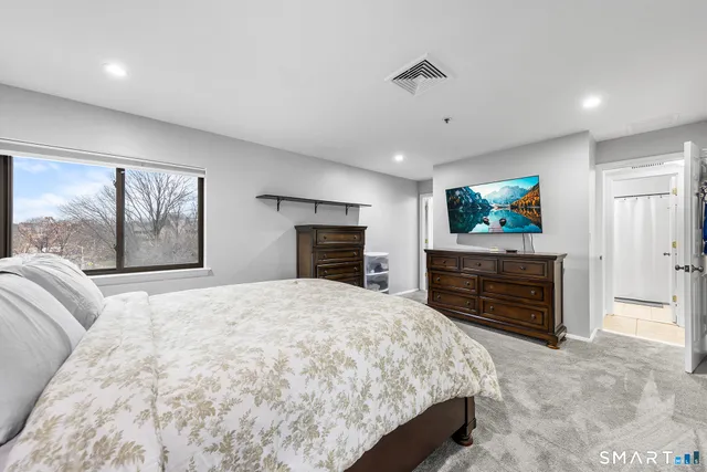 a view of walk in closet with clothes