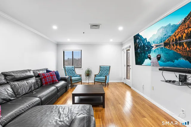 a kitchen with stainless steel appliances granite countertop a refrigerator a stove and a sink