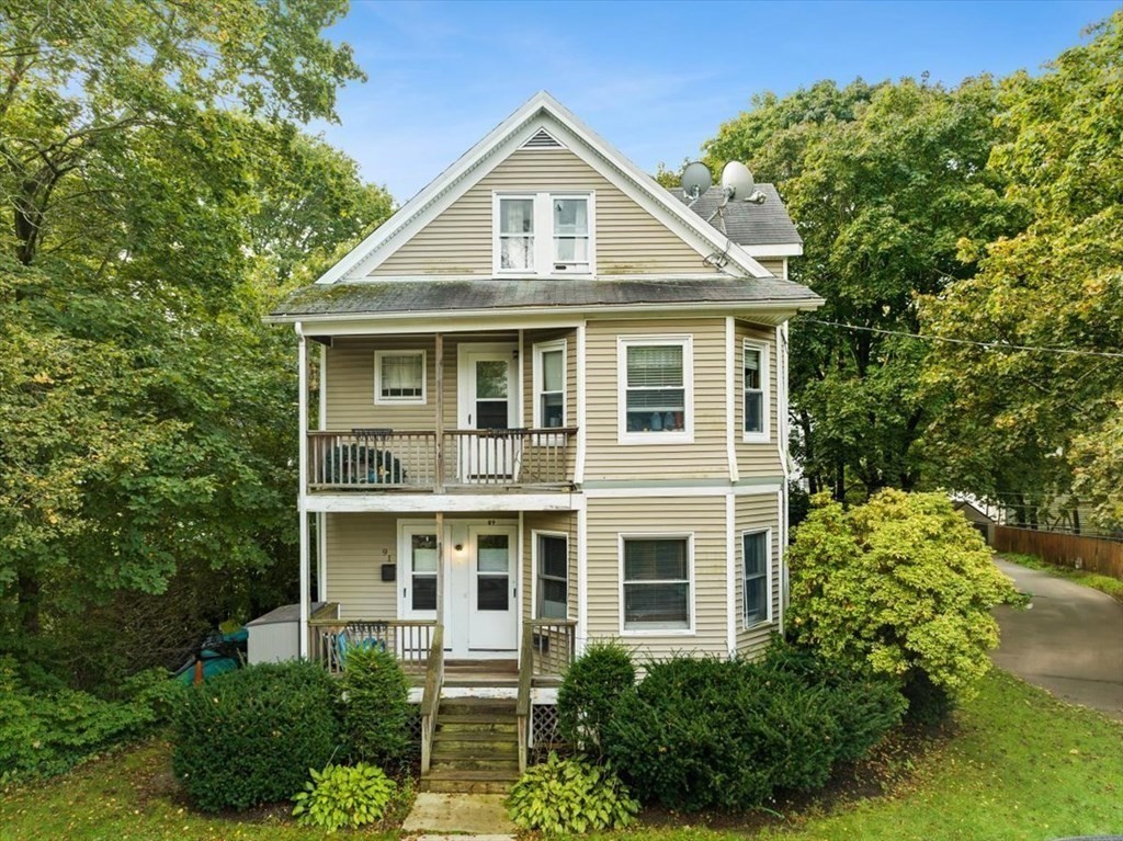 89-91 East Street Mansfield, MA 02048 - Photo 1 of 38 a front view of a house with a yard