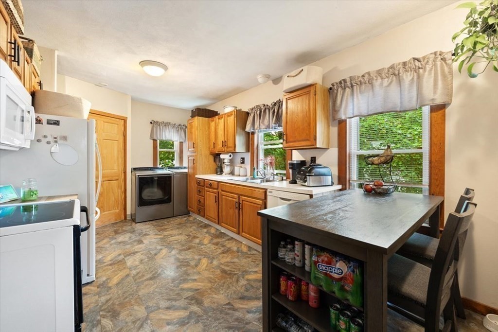 89-91 East Street Mansfield, MA 02048 - Photo 13 of 38 a kitchen with stainless steel appliances granite countertop a stove a sink dishwasher and a refrigerator with wooden floor