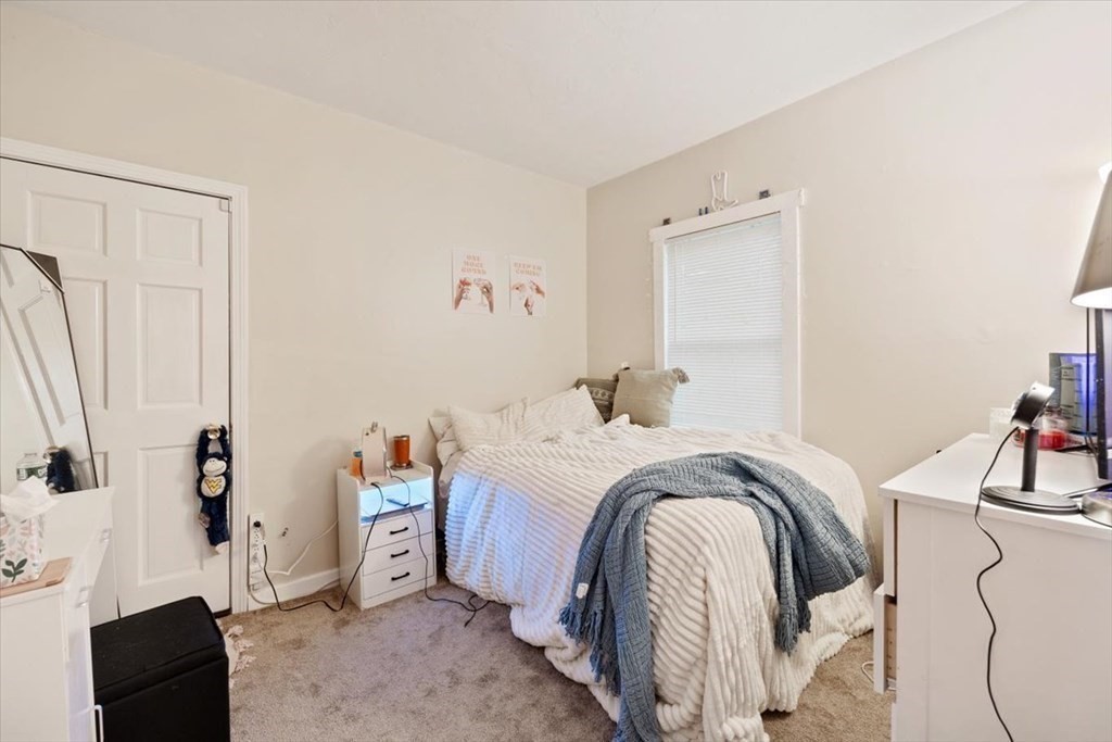 89-91 East Street Mansfield, MA 02048 - Photo 18 of 38 a bedroom with a bed and a mirror