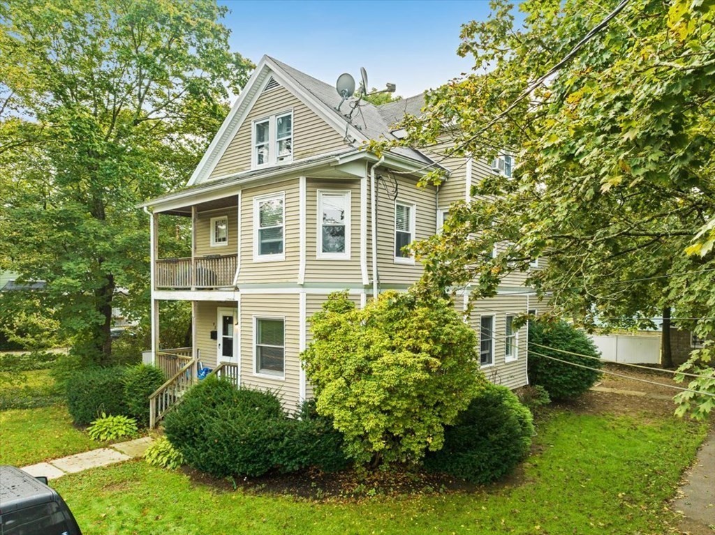 89-91 East Street Mansfield, MA 02048 - Photo 2 of 38 a front view of a house with a garden