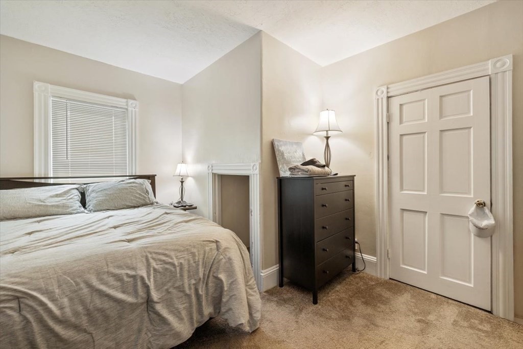 89-91 East Street Mansfield, MA 02048 - Photo 22 of 38 a bedroom with a bed and a lamp