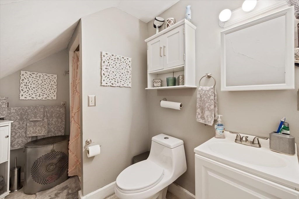 89-91 East Street Mansfield, MA 02048 - Photo 25 of 38 a white toilet sitting next to a bathroom sink