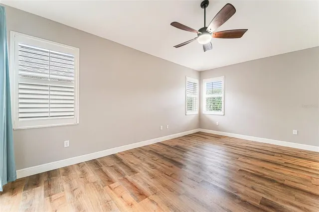 a view of room with window and ceiling fan