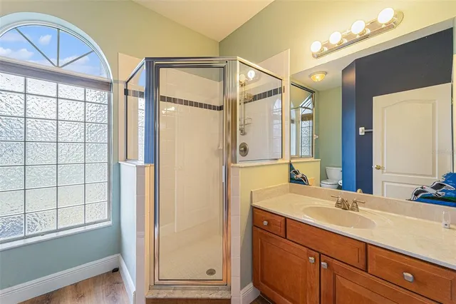 a bathroom with a double vanity sink a mirror and a bathtub
