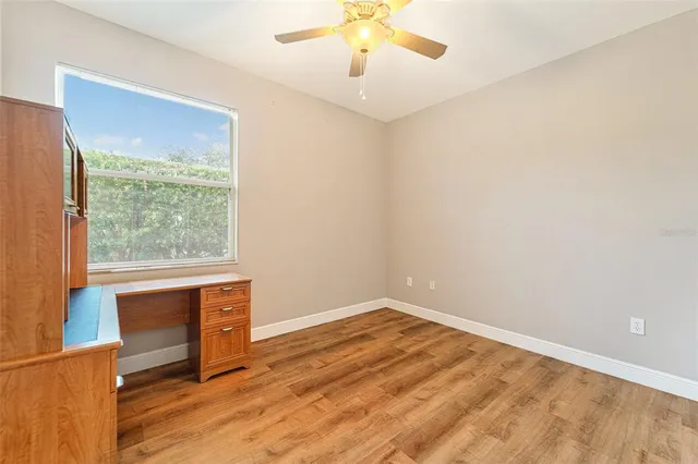 a view of room with window and wooden floor