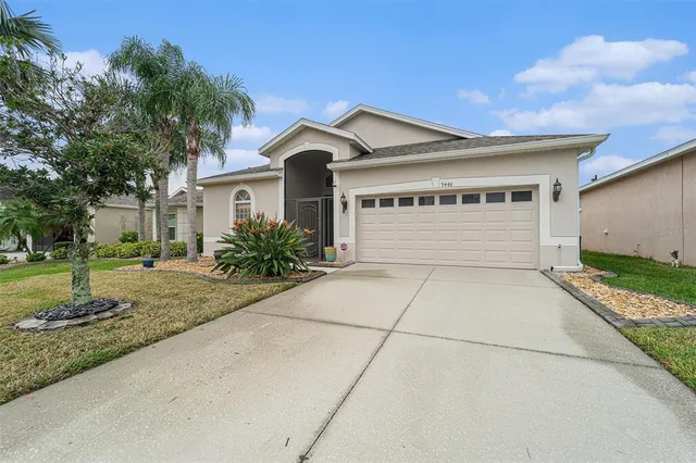 a front view of a house with a yard and garage