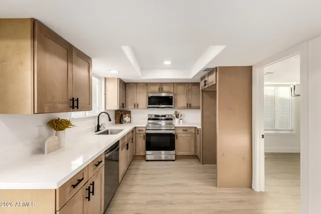 a large kitchen with a stove top oven a sink and dishwasher